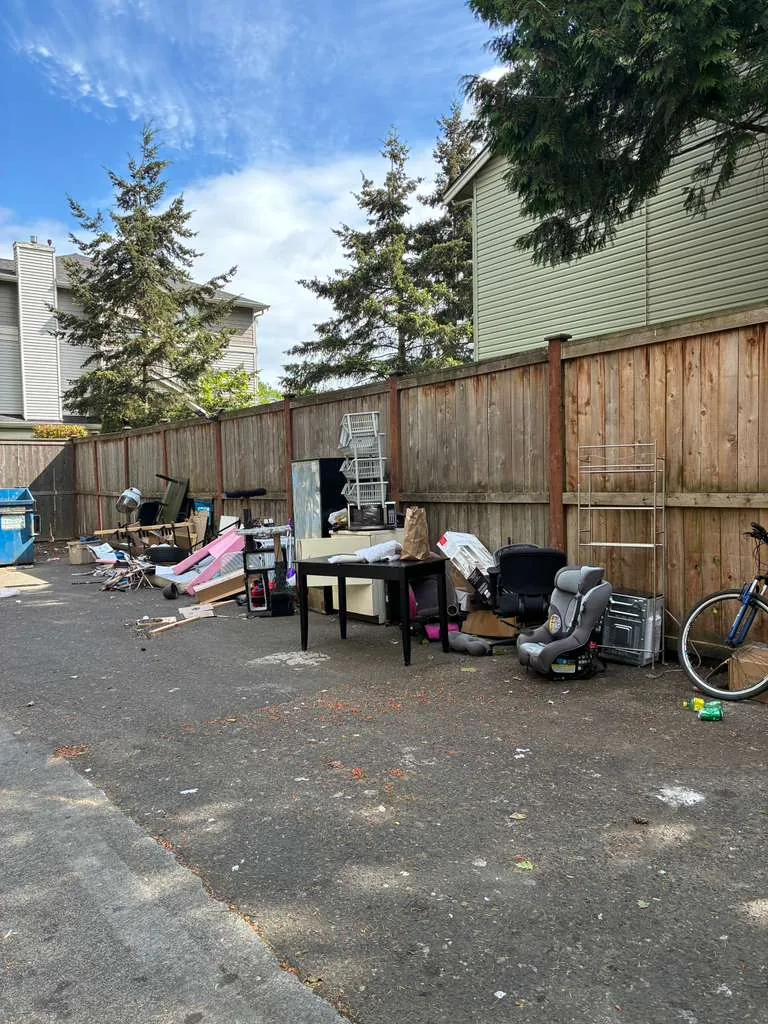 Outdoor property area with furniture and unwanted items before junk removal