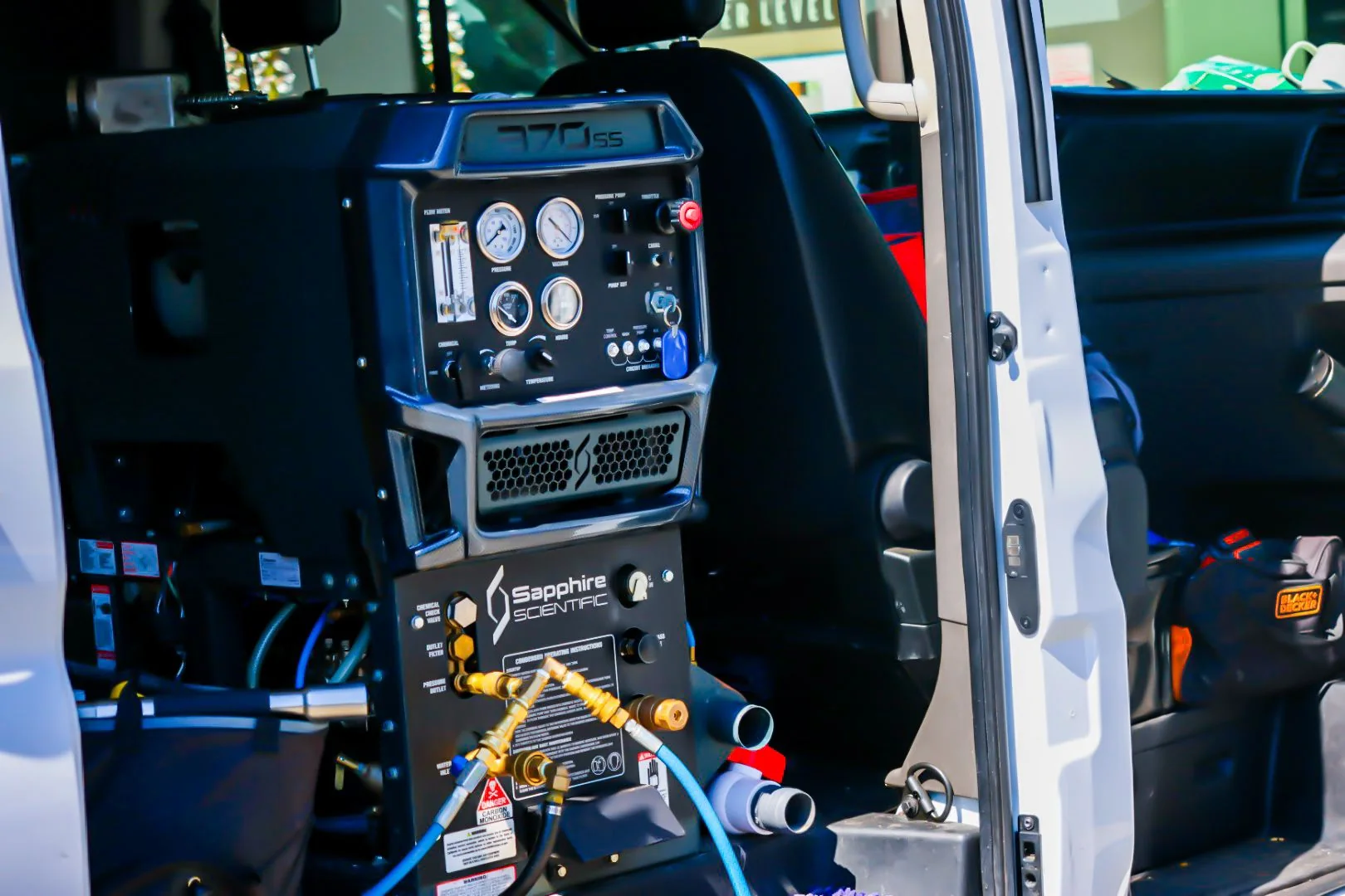 Truck-mounted professional carpet cleaning equipment inside the Emerald City service van